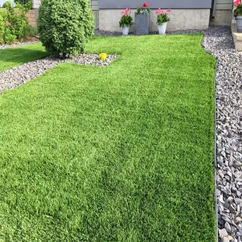 Artificial grass carpet installed in a modern outdoor garden