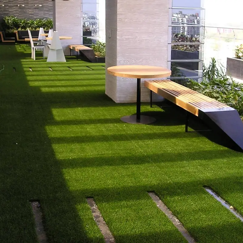 Decorative synthetic grass carpet installed around a seating area