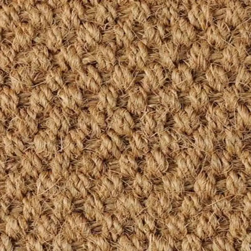 Golden brown jute carpet featuring handcrafted natural fibers for timeless home decoration
